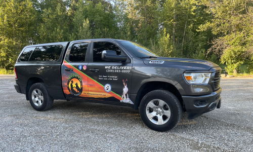 ShakaPaw branded pickup truck parked in a lot on a clear day.